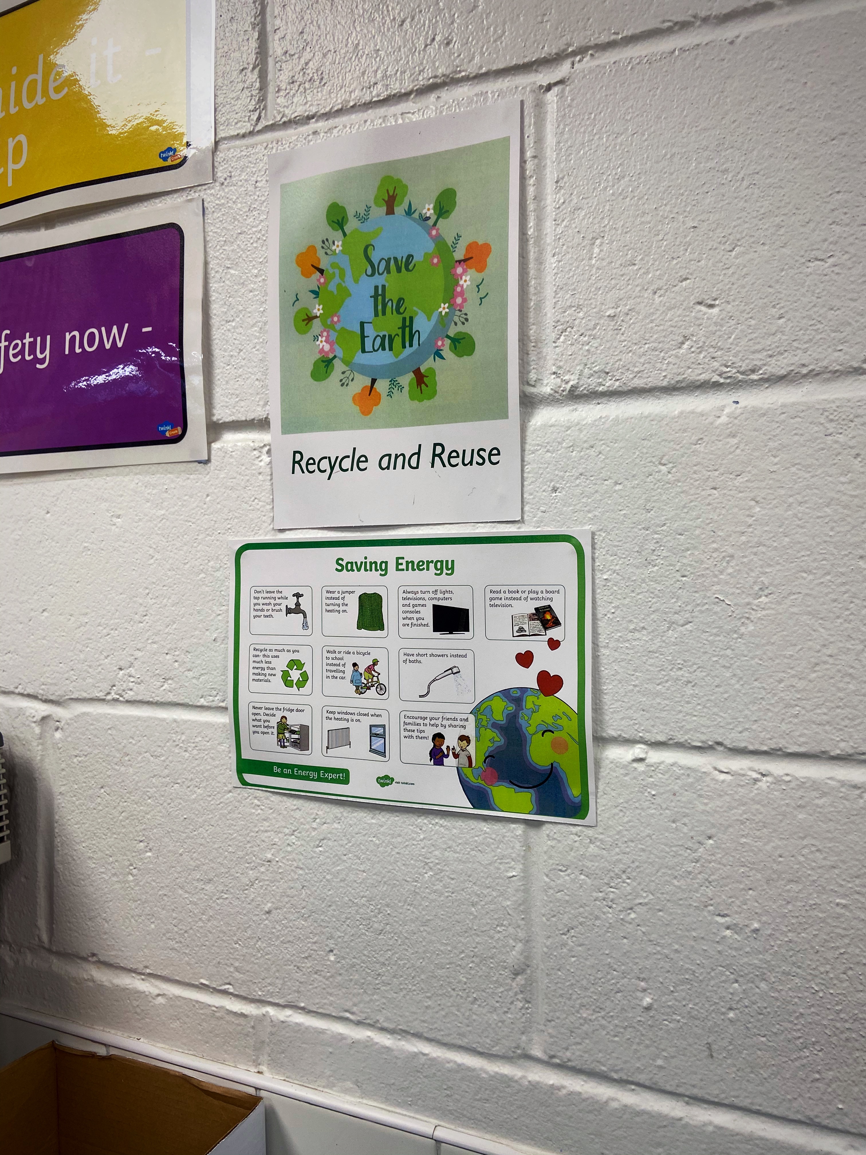 Recycling fact posters and strategies to save energy are displayed around the school